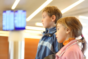 boy and girl in airport blue screens on background