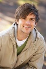 Portrait Of Young Man In Autumn Park