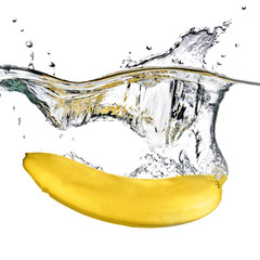 banana dropped into water isolated on white