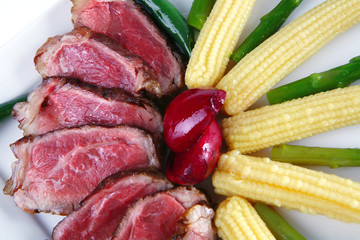 meat served on white with corns