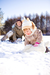 Toddler and her parents in park