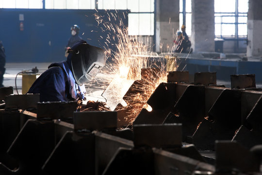 blowtorch cutting metal in factory and sparks