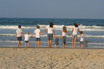 Children walking on the beach holding hands