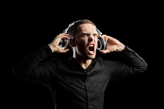 A view of a man with headphones isolated on black background