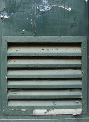green metal grunge door with ventilation grid shaft
