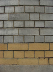 brick wall made of gray and yellow orange bricks
