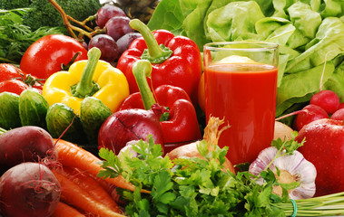 Composition with fresh raw vegetables and glass of juice