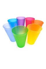 Group of bright plastic cups, rainbow colors, white background