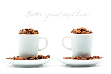 two cups on plates filled with coffee beans