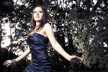 fashion photo of beautiful woman walking in woods