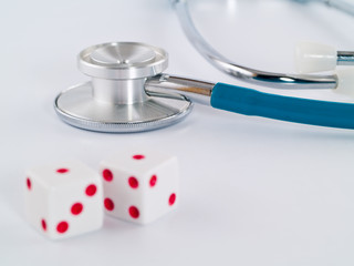 Stethoscope and Dice as a Gambling with your Health Concept