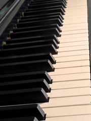 Naklejka premium Piano keys of a very well loved and often played piano in Sepia