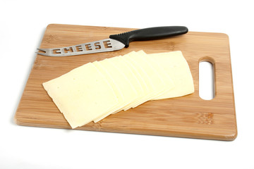sliced cheese and knife on board