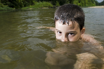 Boy plays in creek