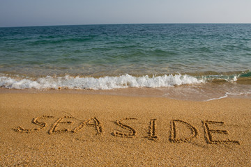 Word seaside on the beach.