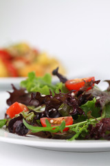 Mixed greens with cherry tomatoes sprinkled with sesame seeds