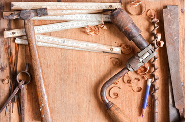composition of grungy old hand tools on wood texture