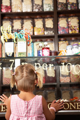 Excited Girl Standing In Sweet Shop