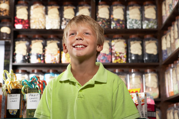 Excited Boy Standing In Sweet Shop