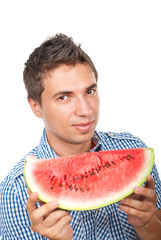 Young man holding a slice of watermelon