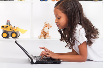 african american girl playing with laptop
