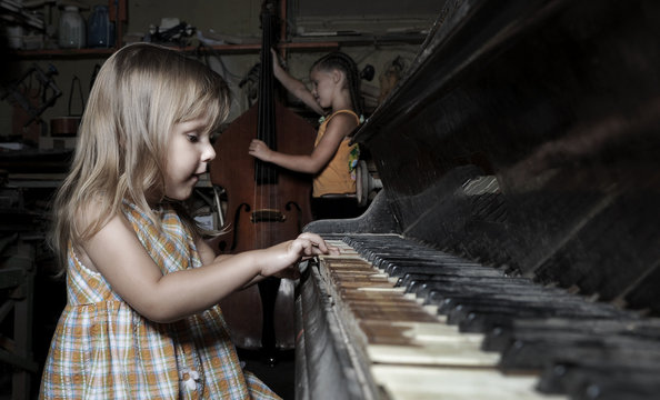 girl playing on an old  piano