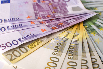 Close-up of the fan Euro banknotes and  coins.