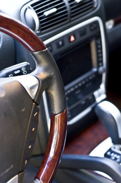 Salon expensive car. Leather-covered steering wheel