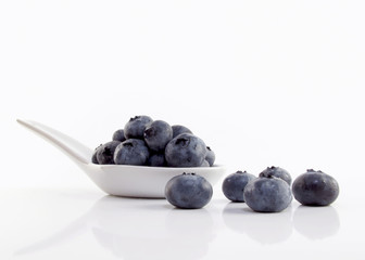 Blueberries on white spoon