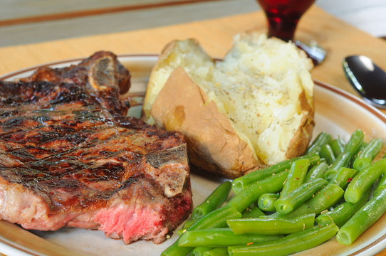 Dinner Of Steak, Baked Potato And Green Beans