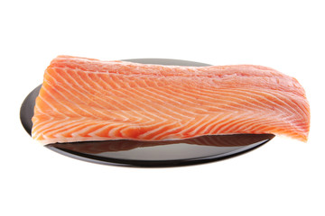 big salmon chunk on black plate