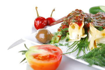 cannelloni with cheese on square white plate