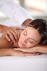 Fototapeta na wymiar Woman relaxing on a massage bed