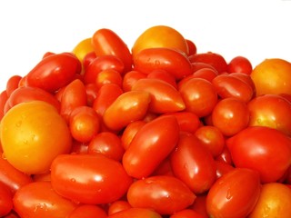 Red and yellow tomatoes on a white background.