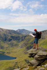 Fototapeta na wymiar Man Reading Map in Mountain Wilderness