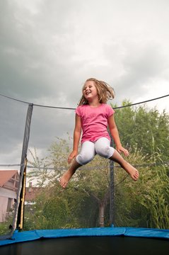 Big fun - child jumping trampoline