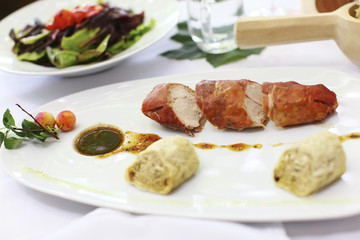 Rabbit wrapped in prosciutto with sauce and dumplings