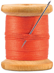 Old wooden vintage bobbin, red thread and needle, isolated vertical macro closeup