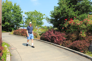 Man walking down sloped sidewalk