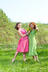 Fototapeta premium funny mother and daughter on green grass