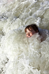 child has fun in the waves