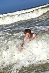 Fototapeta premium child has fun in the waves