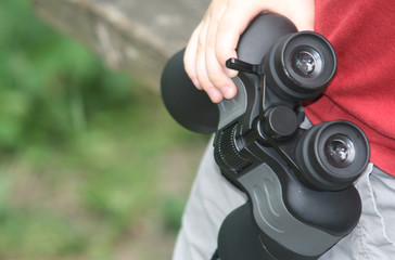 binoculars in boy's arm
