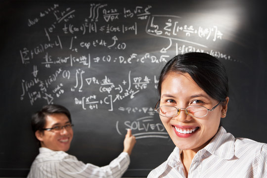 Female student pose  with people working on background