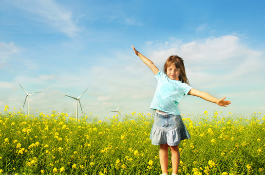 Little girl in front of windmills