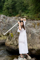 Young girl in white dress with two handed sword