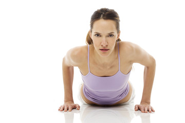 Fototapeta na wymiar Young woman practicing yoga on white background studio