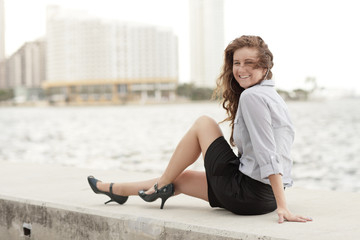 Image of an attractive young businesswoman sitting by the bay