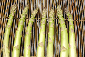 Row of asparagus on bamboo mat