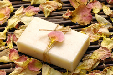 rose withered petals and soap on bamboo mat